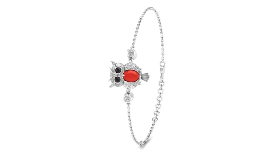 A silver-toned chain bracelet featuring a central charm shaped like a ladybug with a bright red coral oval body and black eyes, set against a plain white background.