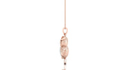 A rose gold pendant necklace featuring a textured, stacked owl charm on a delicate chain, shown against a plain white background with a faint reflection below.