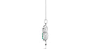 A white gold pendant necklace featuring a stylized bird design with a textured body and a small green emerald gemstone accent, suspended from a delicate silver chain against a white background.