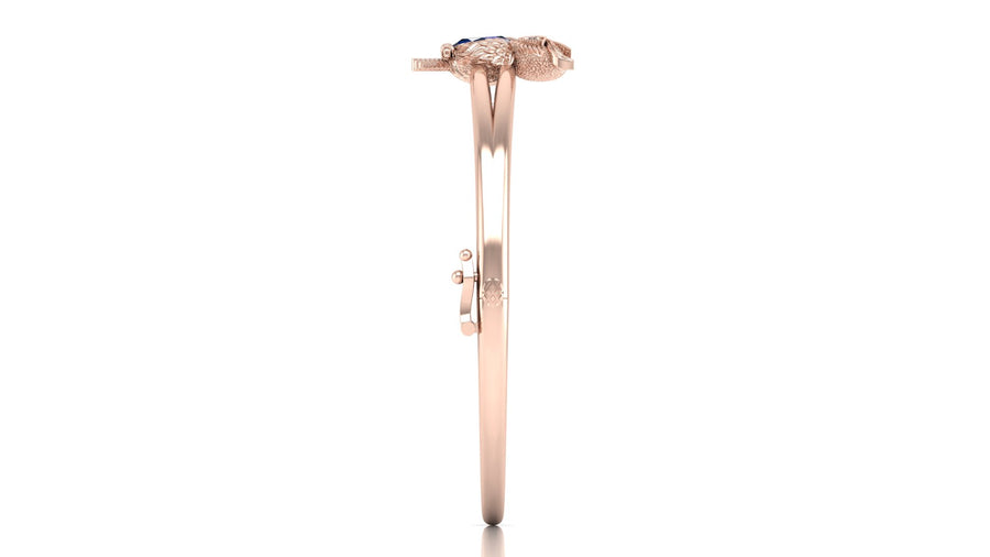 A rose gold bangle bracelet with a textured snake head charm, shown from the side against a plain white background.