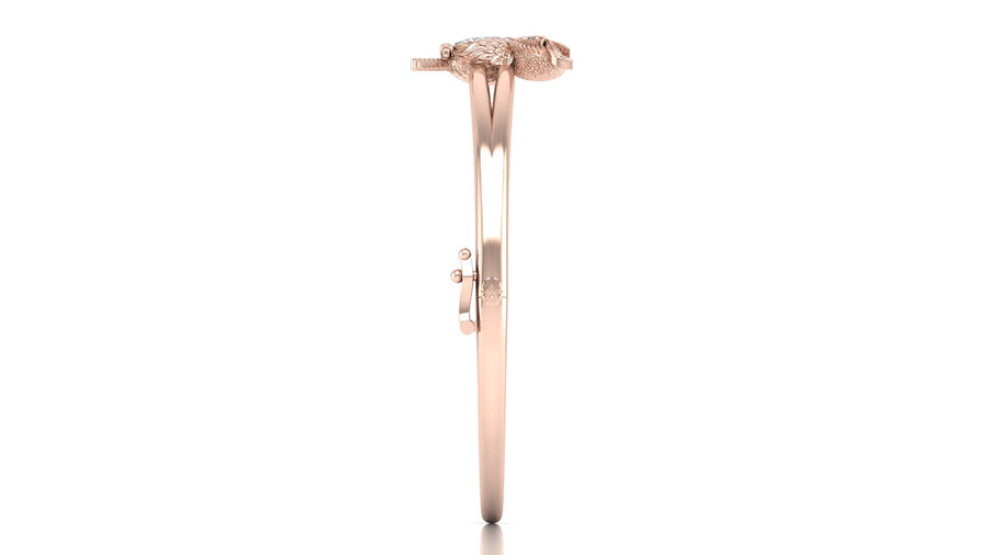 A rose gold bangle bracelet with a central snake motif and a small Diamond gemstone, shown against a plain white background.