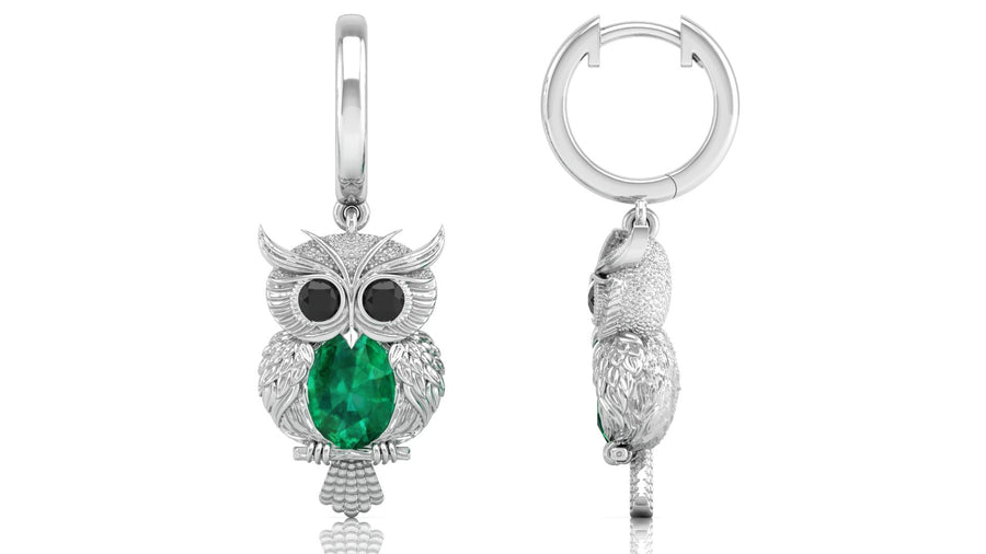 White Gold owl-shaped earrings with green gemstones on a white background