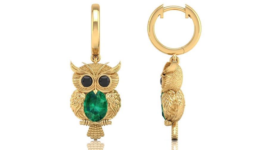 Gold owl-shaped earrings with green gemstones on a white background