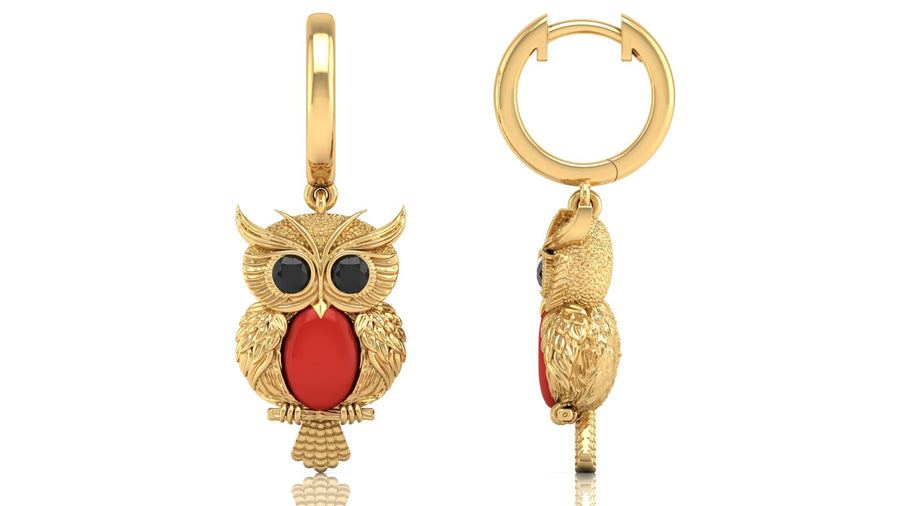 Gold owl-shaped earrings with red coral gemstones on a white background