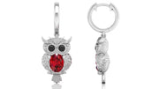 White Gold owl-shaped earrings with ruby gemstones on a white background