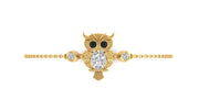 A gold owl pendant bracelet featuring a large diamond center stone, black stone eyes, and small clear accent stones on either side, set on a delicate gold chain against a plain white background.