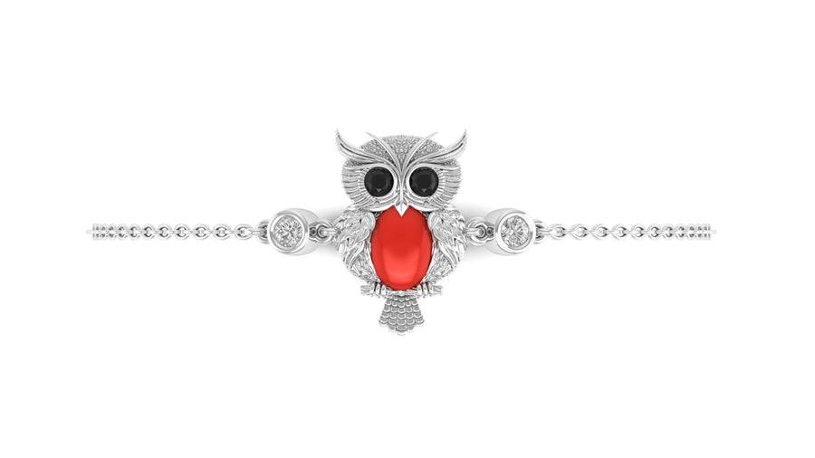 A silver owl pendant bracelet with a large red coral gemstone and black eyes, displayed on a clean white background.