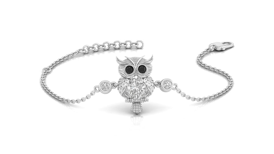 A silver-toned chain bracelet featuring a central owl charm with black eyes and clear crystal details, displayed on a clean white background.