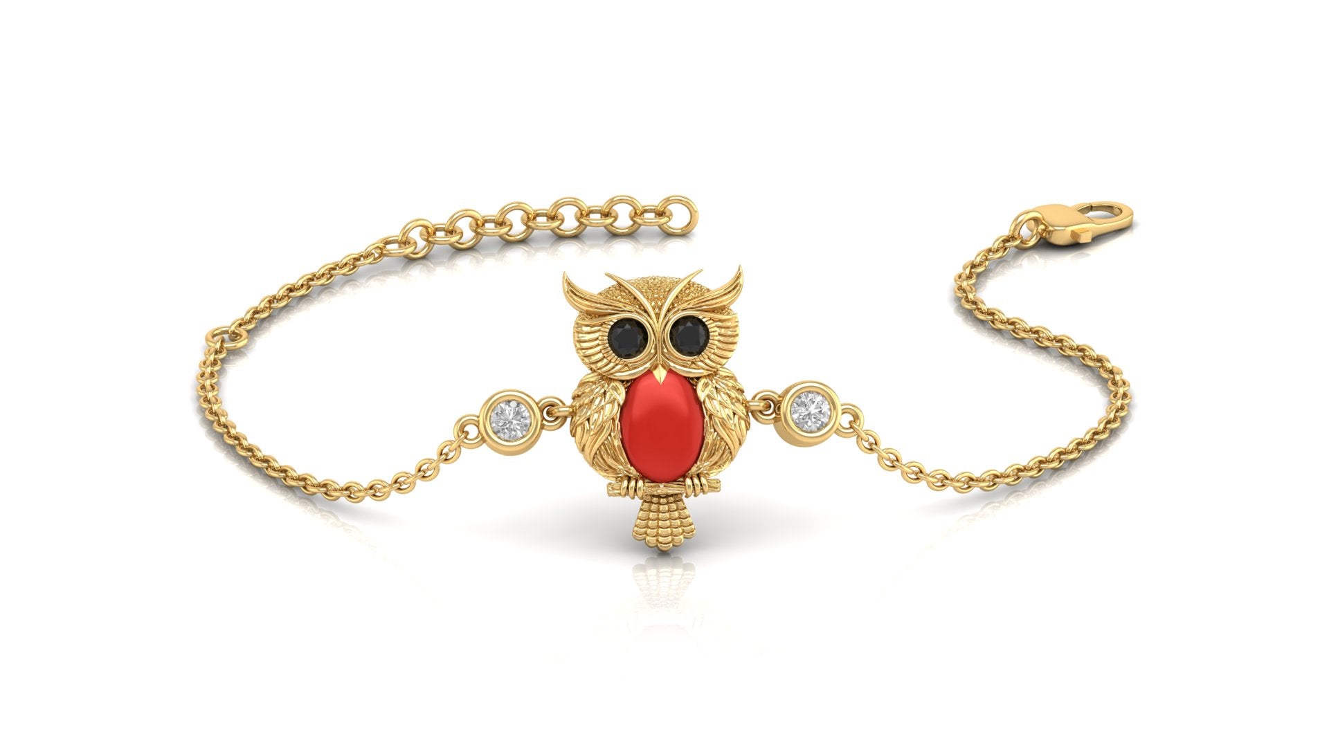 A gold chain bracelet featuring an owl pendant with a red coral for a beak, black stones for eyes, and two small clear stones on either side, shown on a white background.