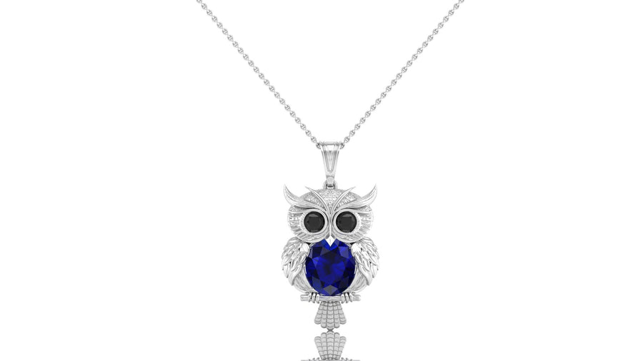 Gold necklace with a blue sapphire gemstone in the centre, pendant on a white background