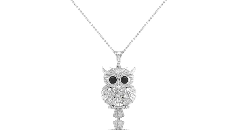 A white gold owl pendant necklace with sparkling diamond stones and black stone eyes, suspended from a delicate silver chain against a plain white background.