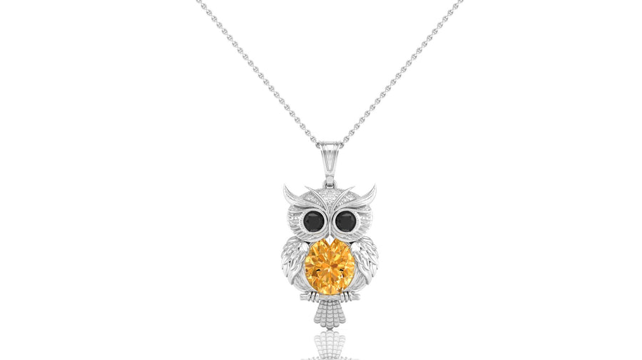 A white gold owl pendant necklace featuring a large round yellow sapphire gemstone in the center, set against a plain white background.