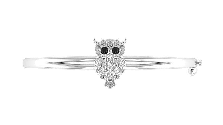 A white gold bangle bracelet featuring a central cluster of clear Diamond gemstone and black stone eyes, set against a plain white background.