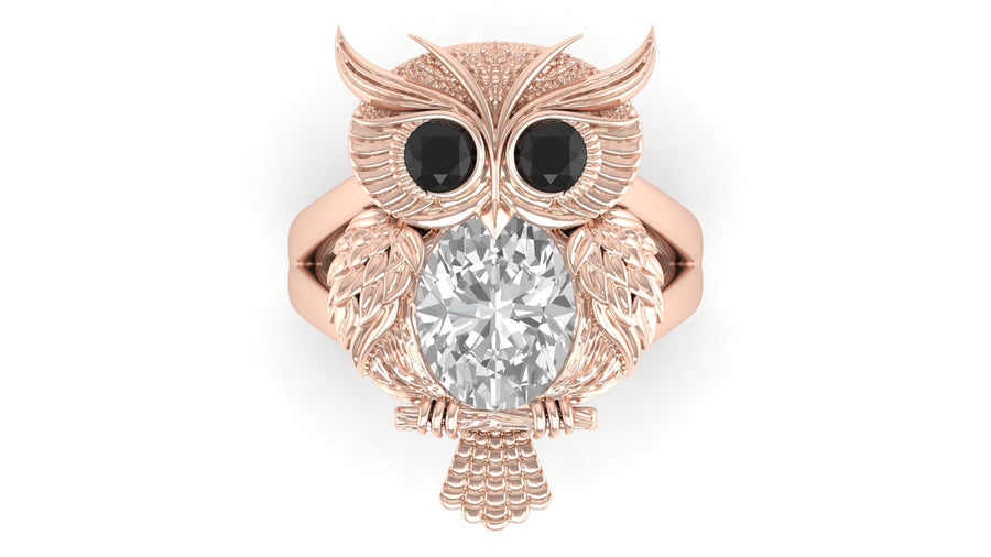Rose gold owl-shaped brooch with a diamond gemstone on a white background