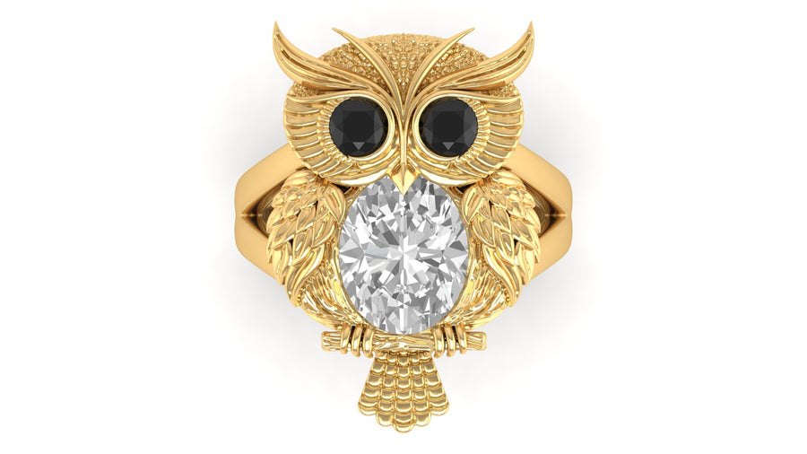Gold owl-shaped ring with a diamond gemstone on a white background