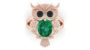 Rose gold owl-shaped brooch with a green gemstone on a white background