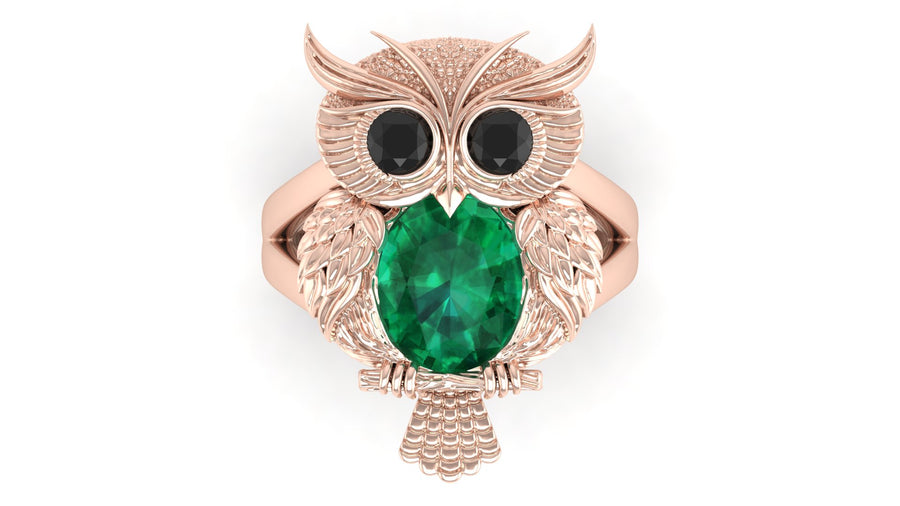 Rose gold owl-shaped brooch with a green gemstone on a white background