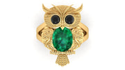 Gold owl-shaped ring with a green gemstone on a white background
