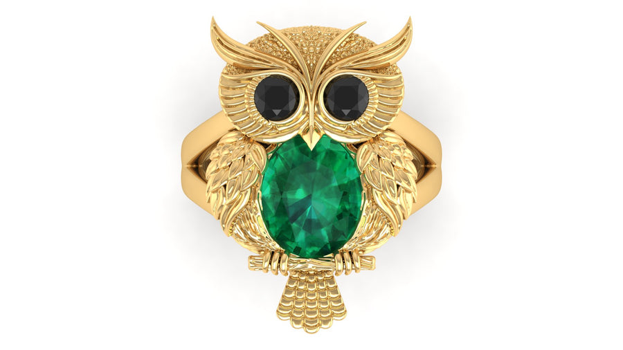 Gold owl-shaped ring with a green gemstone on a white background