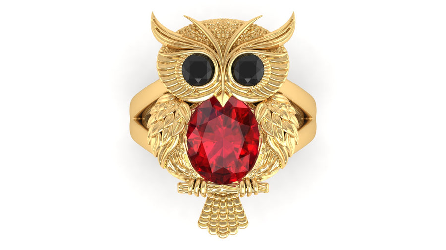 Gold owl-shaped ring with a ruby gemstone on a white background