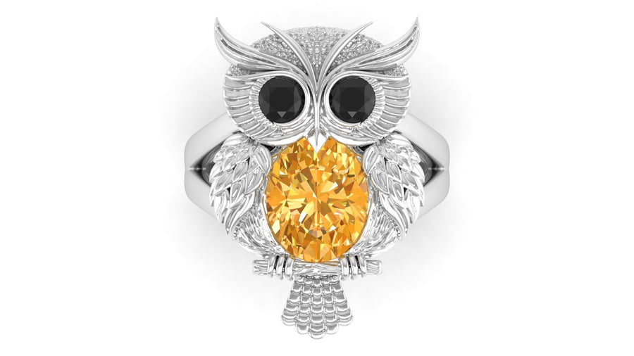 White Gold owl ring with a yellow sapphire gemstone on a white background